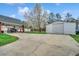 Spacious driveway with large garage and mature trees at 451 Holly View Ln., Loris, SC 29569