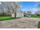Large garage with spacious driveway and mature trees at 451 Holly View Ln., Loris, SC 29569