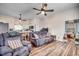 Open-concept living area showcasing hardwood floors, ceiling fans, with the kitchen and bedroom visible at 451 Holly View Ln., Loris, SC 29569