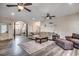 Open-concept living room with multiple ceiling fans, modern flooring, comfortable seating, and arched doorways at 451 Holly View Ln., Loris, SC 29569