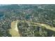 Aerial view of community showcasing the location, lake, and mature trees at 4514 Wagon Run Circle, Murrells Inlet, SC 29576