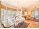 Sunlit dining area featuring a bay window, hardwood floors, and cozy seating arrangement at 4514 Wagon Run Circle, Murrells Inlet, SC 29576