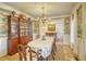 Formal dining room boasting a vintage hutch, chandelier, and unique patterned wallpaper at 4514 Wagon Run Circle, Murrells Inlet, SC 29576