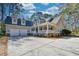 Lovely home with dormers and a wide porch, set back on an expansive driveway and lawn at 4514 Wagon Run Circle, Murrells Inlet, SC 29576