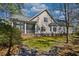 Back of the house with a screened porch and a well-maintained lawn at 4514 Wagon Run Circle, Murrells Inlet, SC 29576