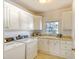Bright laundry room with plenty of cabinet space, a sink, and washer and dryer at 4514 Wagon Run Circle, Murrells Inlet, SC 29576