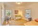 Cozy living room features natural light, hardwood floors, and charming floral sofa at 4514 Wagon Run Circle, Murrells Inlet, SC 29576