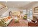 Bright and airy living room featuring hardwood floors, fireplace, and elegant staircase at 4514 Wagon Run Circle, Murrells Inlet, SC 29576