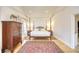 Spacious main bedroom with hardwood floors, four-poster bed, and abundant natural light at 4514 Wagon Run Circle, Murrells Inlet, SC 29576