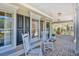 Inviting front porch with brick floor, rocking chairs, and stylish decorations at 4514 Wagon Run Circle, Murrells Inlet, SC 29576