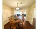 Dining area with wood floors open to the living room, and seating for four around a wooden table at 488 Greenview Dr. # 1, Johnsonville, SC 29555