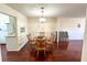 Cozy dining area with wood floors, a chandelier, and seating for four at 488 Greenview Dr. # 1, Johnsonville, SC 29555