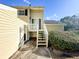Charming yellow townhouse with stairs leading to the front entrance and landscaped bushes at 488 Greenview Dr. # 1, Johnsonville, SC 29555