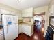 Functional kitchen with white cabinets, wood floors, and a pass-through to the dining and living areas at 488 Greenview Dr. # 1, Johnsonville, SC 29555