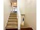 Carpeted staircase leading to the upper level, offering a seamless transition between floors with a view of the living area at 488 Greenview Dr. # 1, Johnsonville, SC 29555