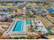 Aerial view of community pool and playground surrounded by palm trees and lounge chairs at 5023 Middleton View Dr., Myrtle Beach, SC 29579