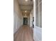 Hallway with wood-look floors, white wainscoting, and exposed wood beams on the ceiling at 5023 Middleton View Dr., Myrtle Beach, SC 29579