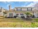 Home exterior with a grassy backyard, a grill, an outdoor dining set and large windows at 503 20Th Ave. N # 45D, North Myrtle Beach, SC 29582