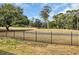 Lush green backyard featuring an iron fence and distant golf course views, perfect for relaxation and recreation at 503 20Th Ave. N # 45D, North Myrtle Beach, SC 29582