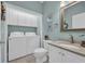 Bright bathroom featuring vanity with granite countertop, toilet, and front-loading washer and dryer at 503 20Th Ave. N # 45D, North Myrtle Beach, SC 29582