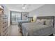 Bedroom featuring two full-sized beds with gray headboards, a window, and wood flooring at 503 20Th Ave. N # 45D, North Myrtle Beach, SC 29582