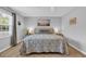 Bedroom with a large window, side tables with lamps, and a bed with an ornate patterned comforter at 503 20Th Ave. N # 45D, North Myrtle Beach, SC 29582