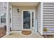 Inviting front entrance with decorative welcome sign, glass door, and neutral siding at 503 20Th Ave. N # 45D, North Myrtle Beach, SC 29582