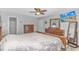 Bedroom with a spacious layout featuring a large bed, dressers, closet access, and a ceiling fan at 510 21St Ave. N, North Myrtle Beach, SC 29582
