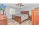 Cozy bedroom featuring a large bed, wood furniture, and a bright window for natural light at 510 21St Ave. N, North Myrtle Beach, SC 29582