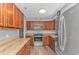Well-lit kitchen featuring stainless steel appliances, granite countertops, and wood cabinets at 510 21St Ave. N, North Myrtle Beach, SC 29582