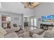 Spacious living area with a ceiling fan, stylish furniture, and seamless flow into the adjacent dining and kitchen spaces at 510 21St Ave. N, North Myrtle Beach, SC 29582