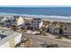 Aerial view of beach homes showcasing oceanfront property and beach access at 5100 Ocean Blvd. N, North Myrtle Beach, SC 29582