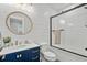 Bright bathroom features shiplap walls, navy vanity, and a modern glass-enclosed shower at 5100 Ocean Blvd. N, North Myrtle Beach, SC 29582