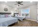 Bedroom with two beds, hardwood floors, and window offering abundant natural light at 5100 Ocean Blvd. N, North Myrtle Beach, SC 29582