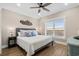 Cozy bedroom with a queen bed, hardwood floors, and large windows with natural light at 5100 Ocean Blvd. N, North Myrtle Beach, SC 29582
