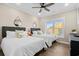 Bedroom with two beds, ceiling fan, and window offering abundant natural light at 5100 Ocean Blvd. N, North Myrtle Beach, SC 29582