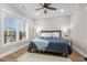 Bright bedroom with a bed, hardwood floors, and large window providing ample natural light at 5100 Ocean Blvd. N, North Myrtle Beach, SC 29582