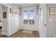 Welcoming entryway with wood-look flooring, hooks, and decorative nautical accents at 5100 Ocean Blvd. N, North Myrtle Beach, SC 29582