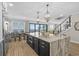 Open-concept kitchen with a large island, modern lighting, and view of the ocean at 5100 Ocean Blvd. N, North Myrtle Beach, SC 29582