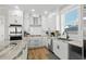 Bright kitchen featuring white cabinets, stainless steel appliances, and granite countertops at 5100 Ocean Blvd. N, North Myrtle Beach, SC 29582