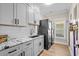 Well-organized laundry room with modern appliances, cabinets, and marble countertop at 5100 Ocean Blvd. N, North Myrtle Beach, SC 29582