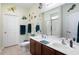 Well-lit bathroom with double sinks, a large mirror, and nautical-themed decorations at 545 Tourmaline Dr., Little River, SC 29566
