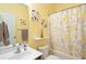 Yellow bathroom featuring a shower and tub combo, a decorative mirror, and towel racks at 545 Tourmaline Dr., Little River, SC 29566
