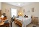Cozy bedroom is staged with neutral colors, a ceiling fan, and a bright window at 545 Tourmaline Dr., Little River, SC 29566
