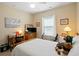 Bedroom features a ceiling fan, a bright window, and traditional-style decor at 545 Tourmaline Dr., Little River, SC 29566