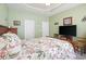 Spacious bedroom with a large bed, flat-screen TV, and two closets for storage at 545 Tourmaline Dr., Little River, SC 29566