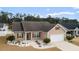 Charming single-story home with well-manicured landscaping and attached garage at 545 Tourmaline Dr., Little River, SC 29566
