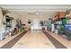 Spacious two-car garage offering ample space for storage and organization, equipped with tools and outdoor equipment at 545 Tourmaline Dr., Little River, SC 29566
