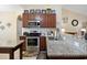 Well-lit kitchen with granite countertops, stainless steel appliances, and stylish cabinets at 545 Tourmaline Dr., Little River, SC 29566