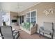 Enclosed porch with ample seating, a ceiling fan, and plenty of natural light at 545 Tourmaline Dr., Little River, SC 29566